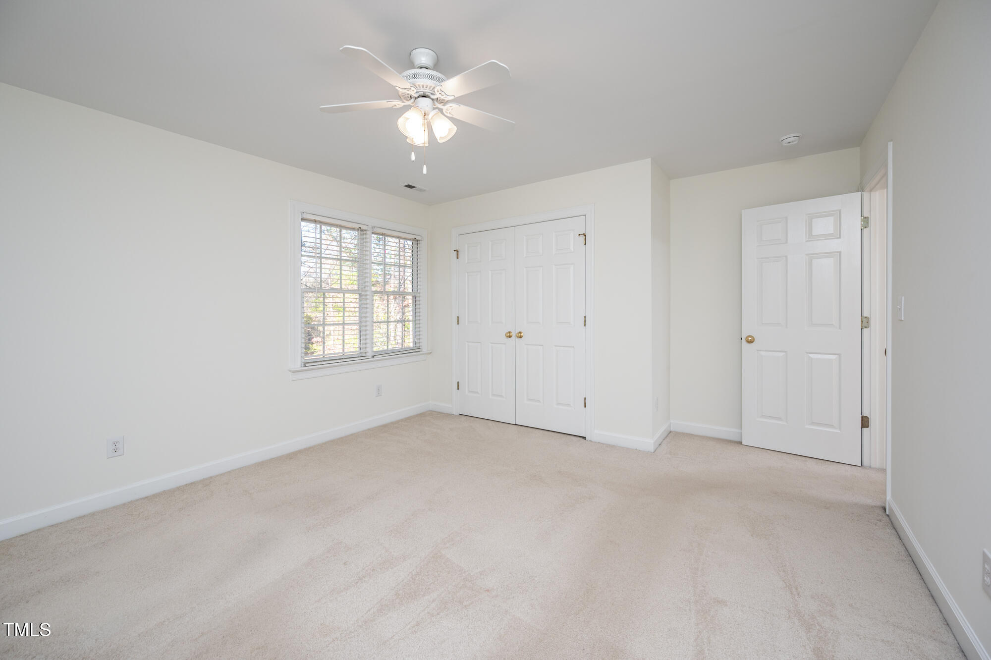 506 Manor Ridge Road Carrboro, NC 27510 - Photo 20 of 30 an empty room with windows and ceiling fan