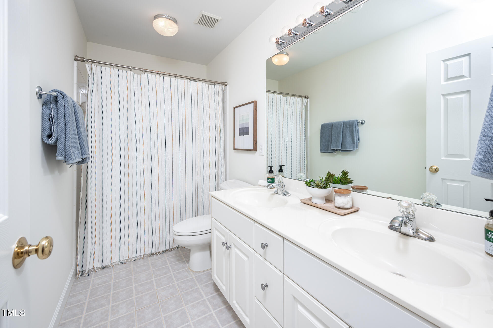 506 Manor Ridge Road Carrboro, NC 27510 - Photo 21 of 30 a bathroom with a double vanity sink and mirror