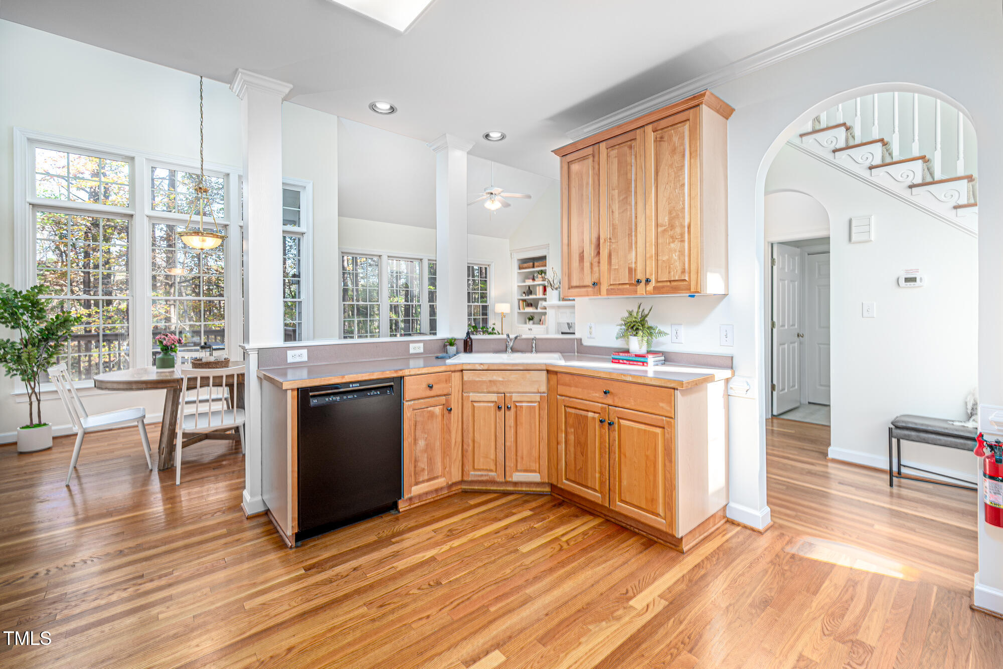 506 Manor Ridge Road Carrboro, NC 27510 - Photo 9 of 30 a kitchen with granite countertop a stove a sink and white cabinets with wooden floors