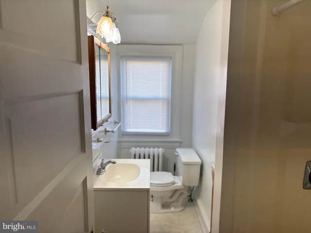 a bathroom with a sink a toilet and mirror