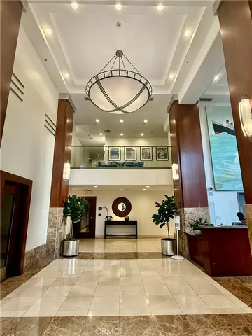 a living room with furniture a rug and white walls