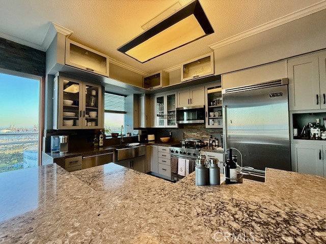 488 East Ocean Boulevard, Unit P2 Long Beach, CA 90802 - Photo 4 of 15 a kitchen with stainless steel appliances granite countertop a stove refrigerator and a sink