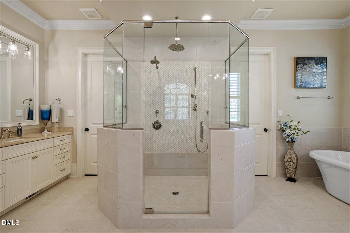 1413 Lily Estates Drive Raleigh, NC 27614 - Photo 19 of 82 a bathroom with a shower sink vanity and mirror
