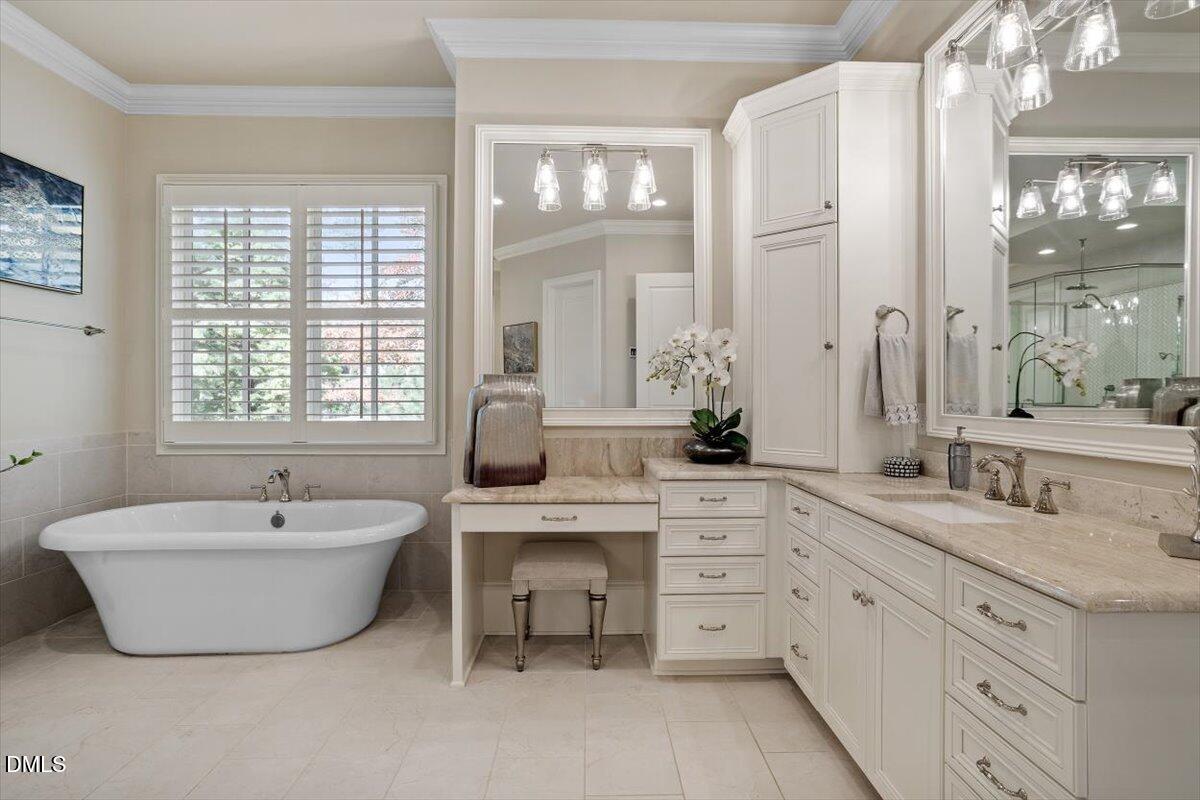 1413 Lily Estates Drive Raleigh, NC 27614 - Photo 21 of 82 a spacious bathroom with a double vanity sink large mirror a bathtub and next to a window