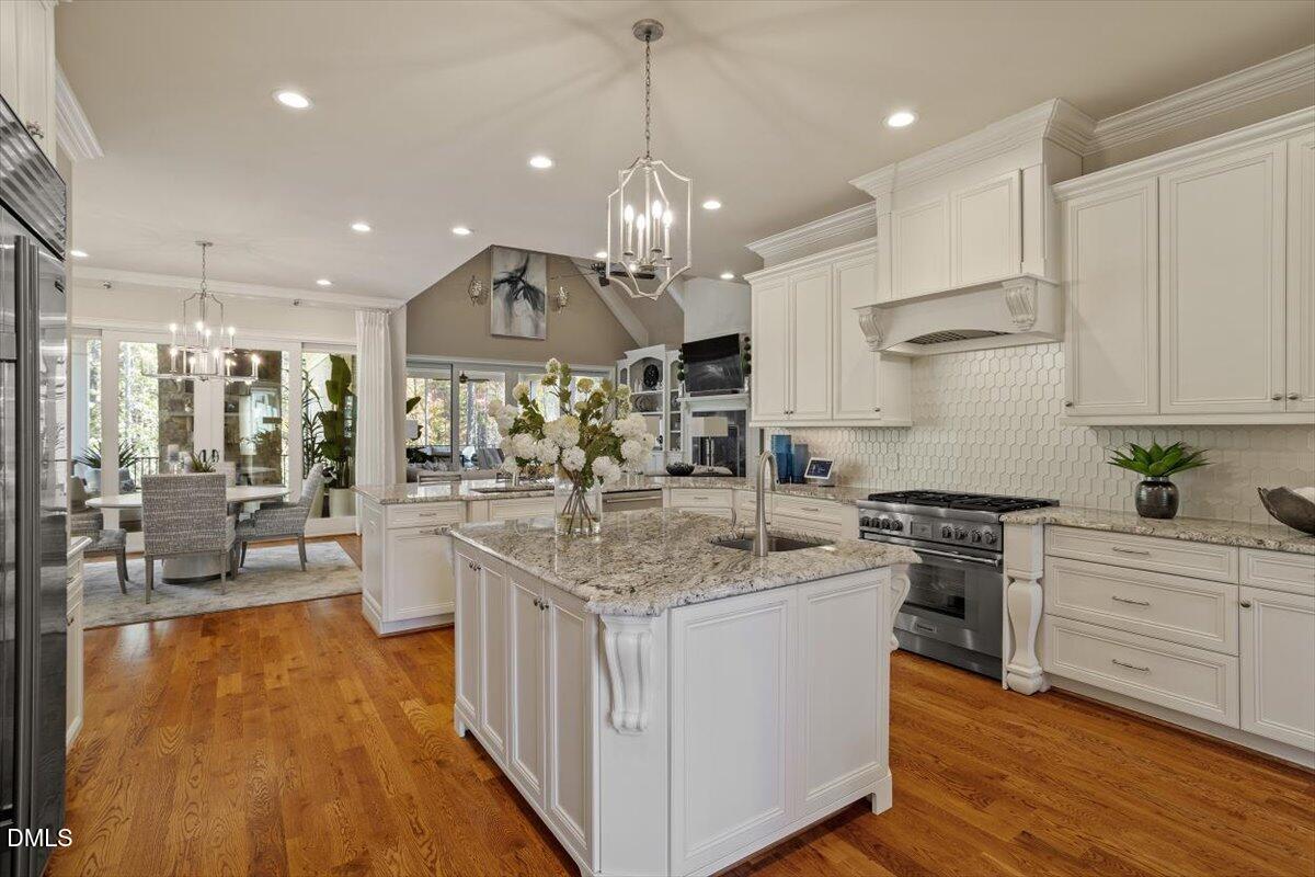 1413 Lily Estates Drive Raleigh, NC 27614 - Photo 25 of 82 a kitchen with stainless steel appliances granite countertop a sink stove and refrigerator