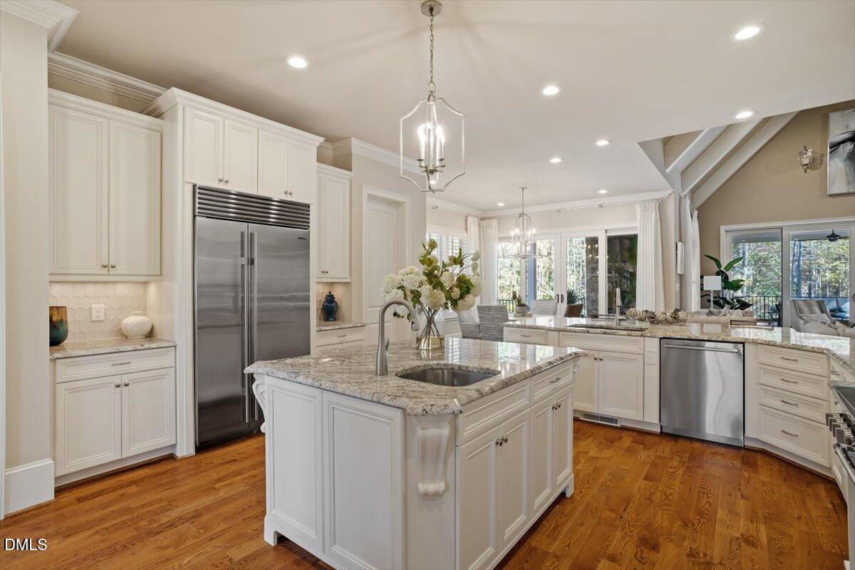 1413 Lily Estates Drive Raleigh, NC 27614 - Photo 26 of 82 a kitchen with stainless steel appliances granite countertop a sink refrigerator and cabinets