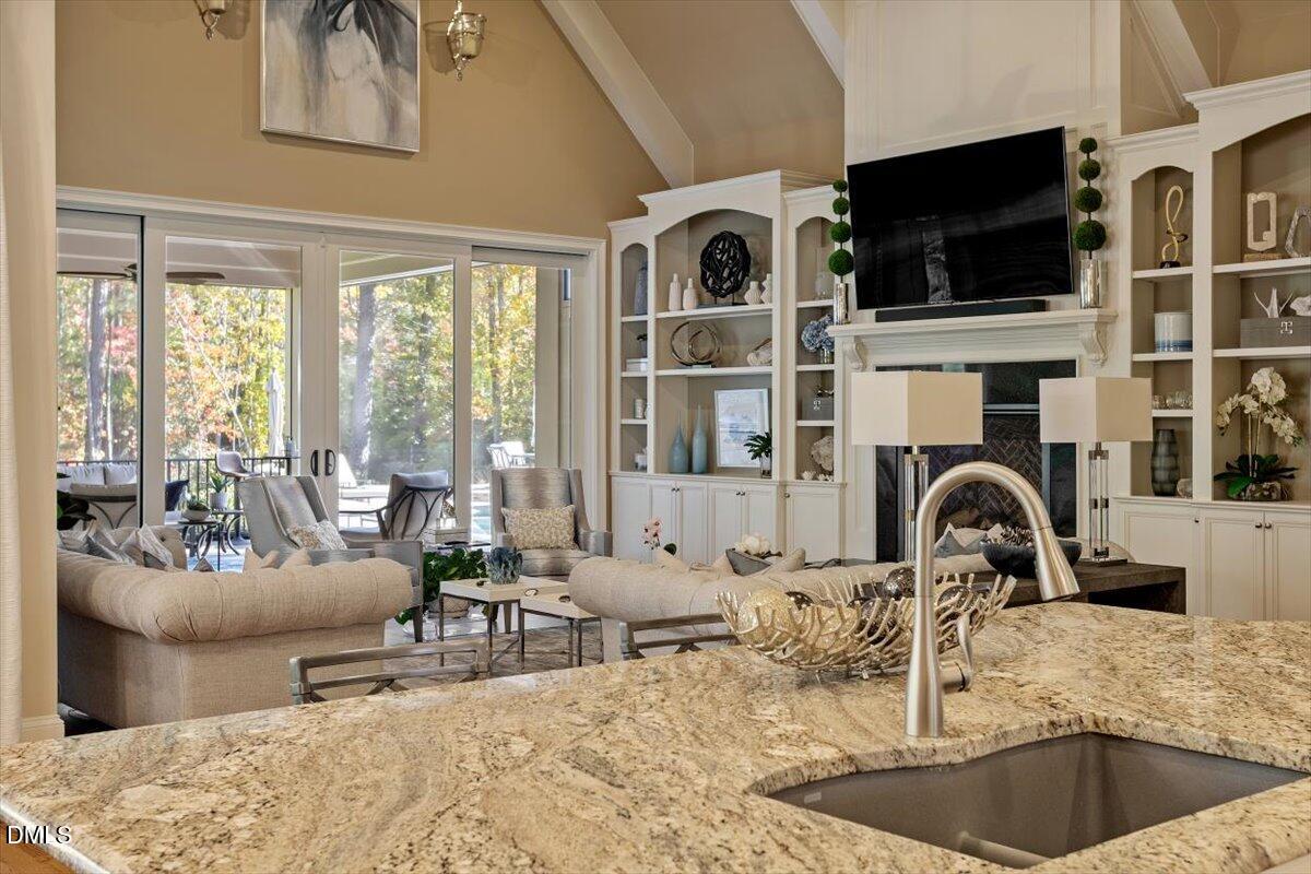 1413 Lily Estates Drive Raleigh, NC 27614 - Photo 33 of 82 a living room with furniture a flat screen tv and a large window