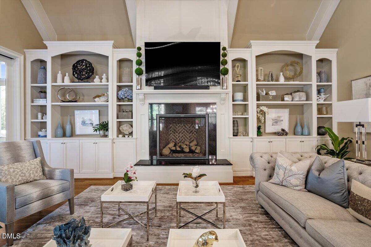 1413 Lily Estates Drive Raleigh, NC 27614 - Photo 36 of 82 a living room with furniture a flat screen tv and a fireplace