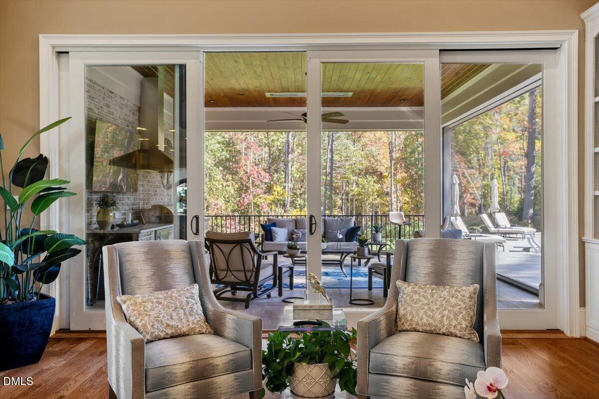1413 Lily Estates Drive Raleigh, NC 27614 - Photo 37 of 82 a living room with furniture and floor to ceiling windows