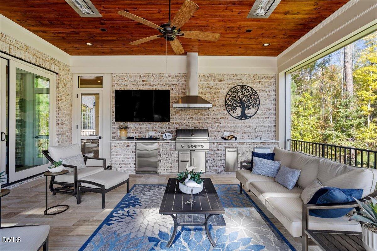 1413 Lily Estates Drive Raleigh, NC 27614 - Photo 39 of 82 a living room with furniture a fireplace and a flat screen tv
