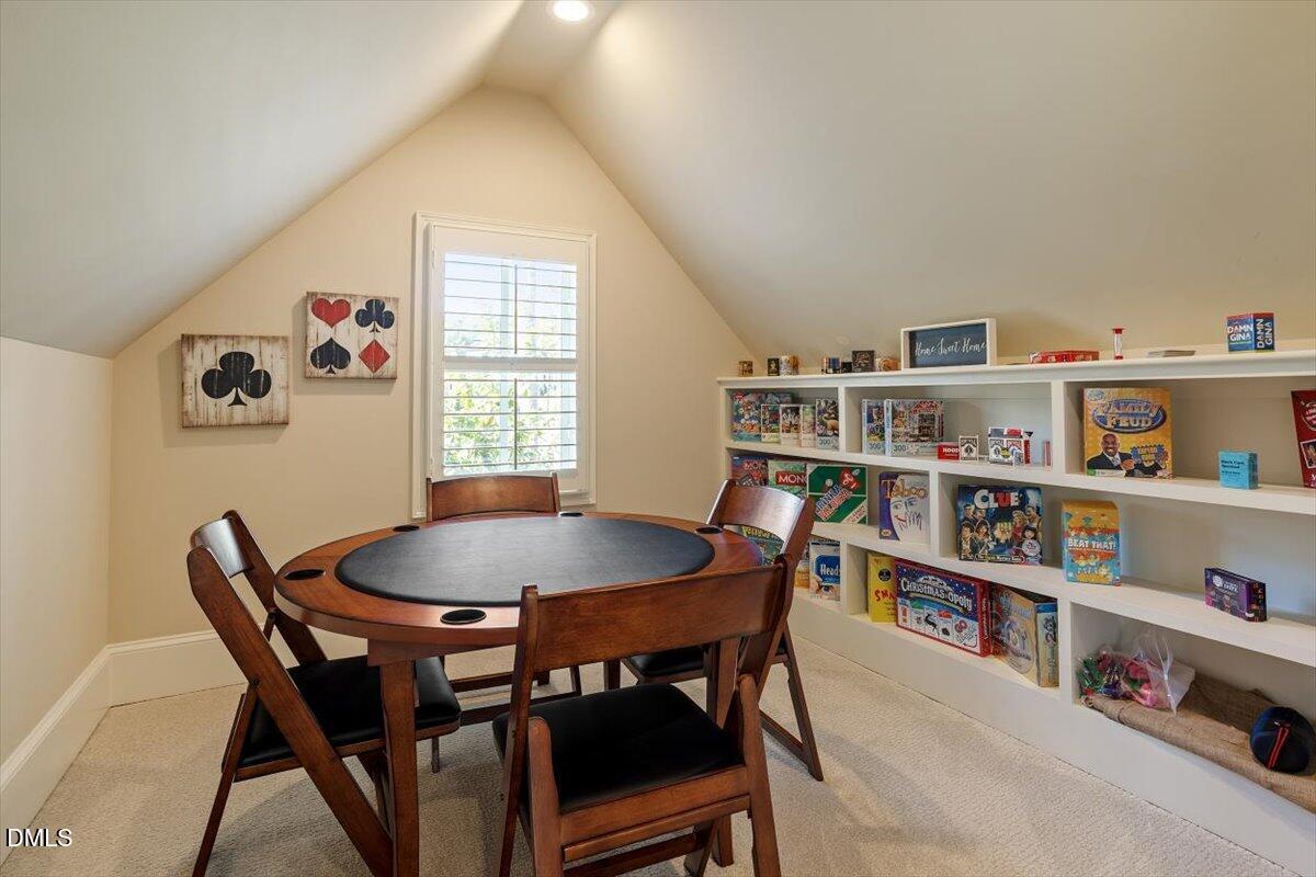 1413 Lily Estates Drive Raleigh, NC 27614 - Photo 54 of 82 a view of a dining room with furniture and a book shelf