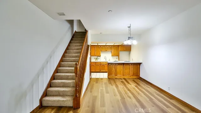 a view of a room with wooden floor and staircase