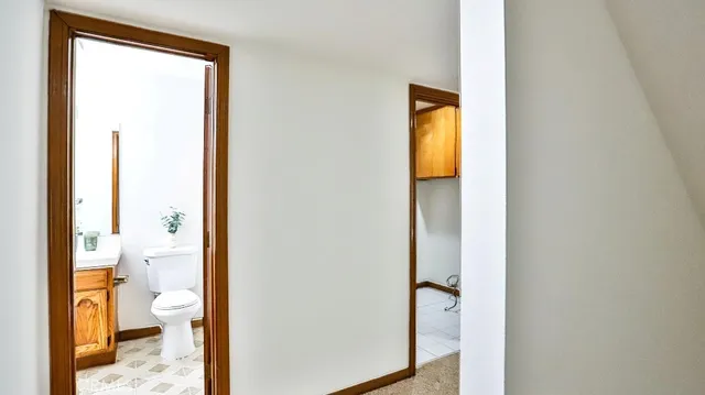 a view of a bathroom from a hallway