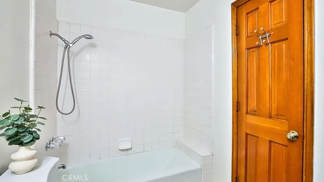 a bathroom with a shower curtain and a window