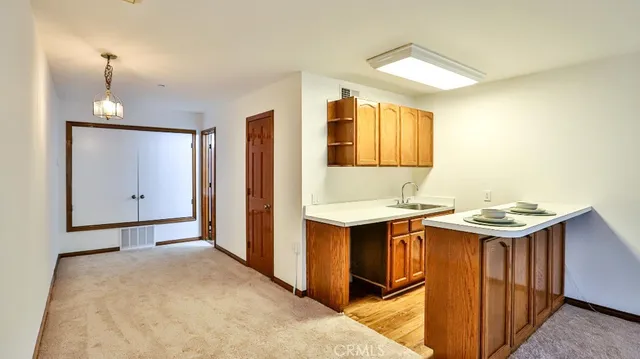 a view of a kitchen with a sink and cabinets
