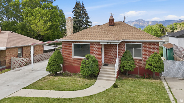 774 37th Street South Ogden, UT 84403 - Photo 44 of 47 Red brick exterior featuring a brown shingle roof and a concrete walkway