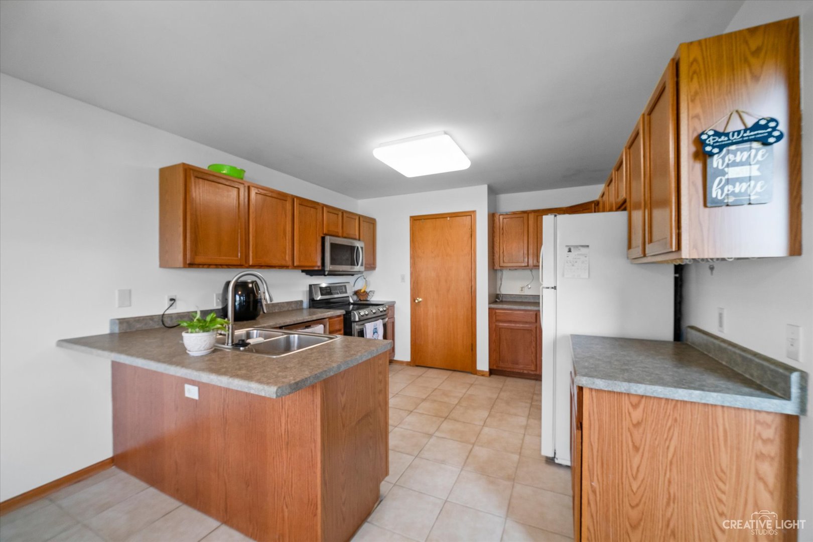 401 Lake Lida Lane Rochelle, IL 61068 - Photo 6 of 20 a kitchen with stainless steel appliances granite countertop a sink stove and refrigerator