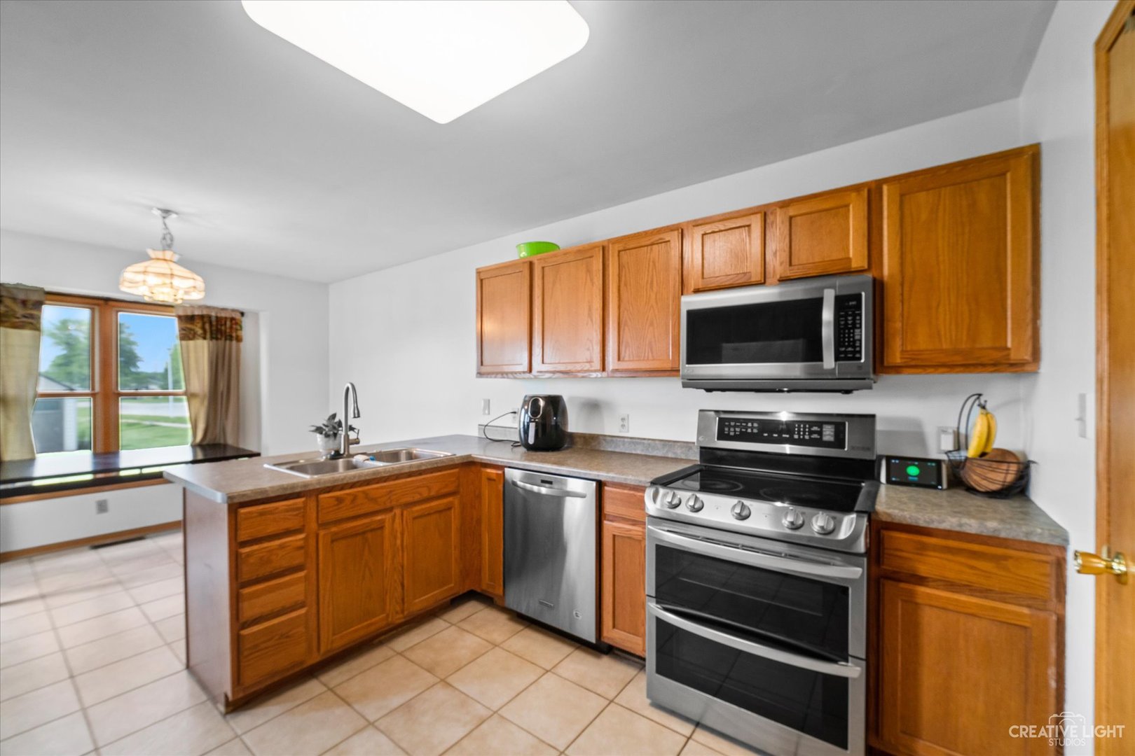 401 Lake Lida Lane Rochelle, IL 61068 - Photo 7 of 20 a kitchen with stainless steel appliances a stove sink and microwave