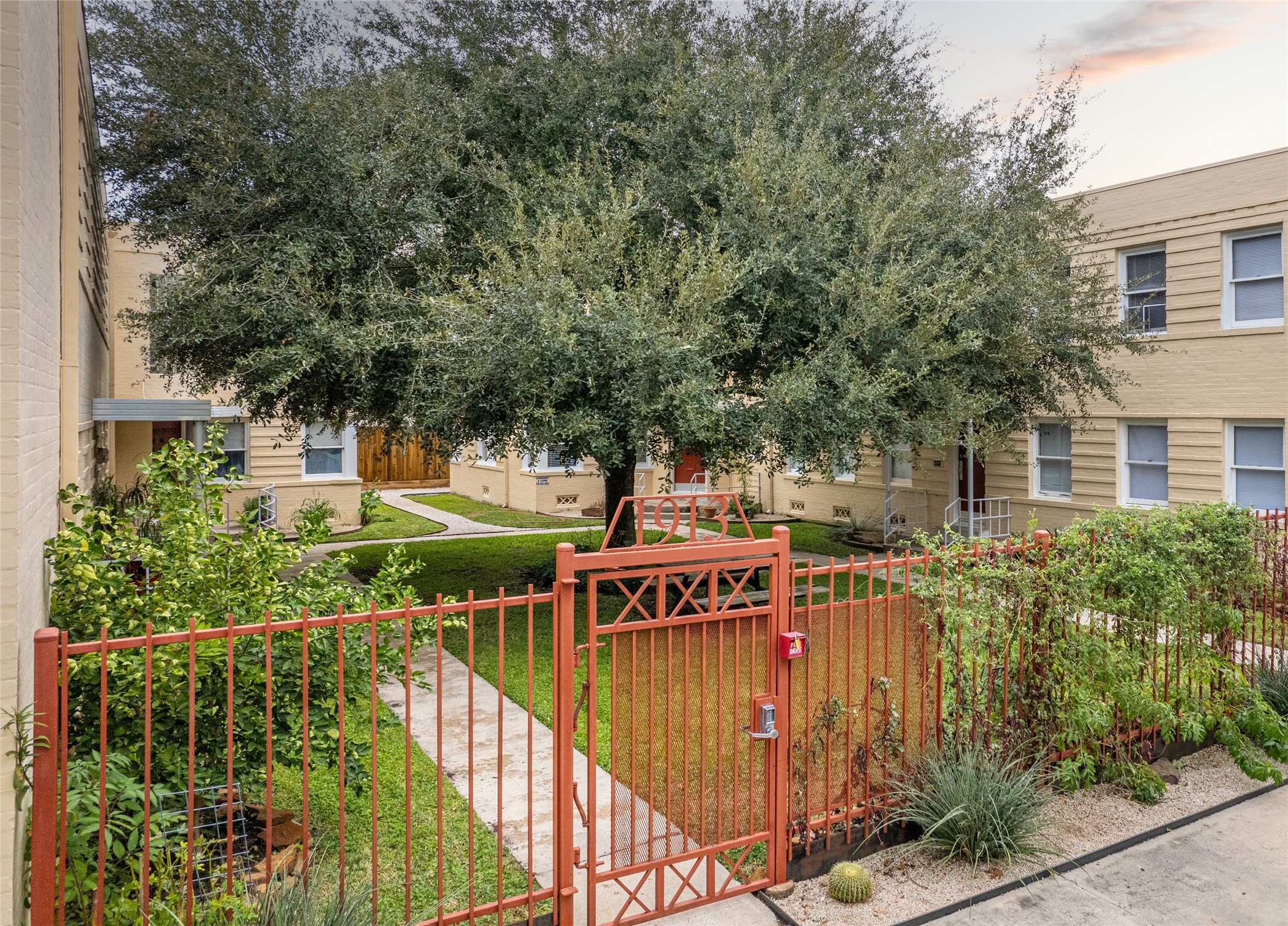 1917 Prospect Street, Unit 1 Houston, TX 77004 - Photo 14 of 16 a view of a pathway with a wrought fence