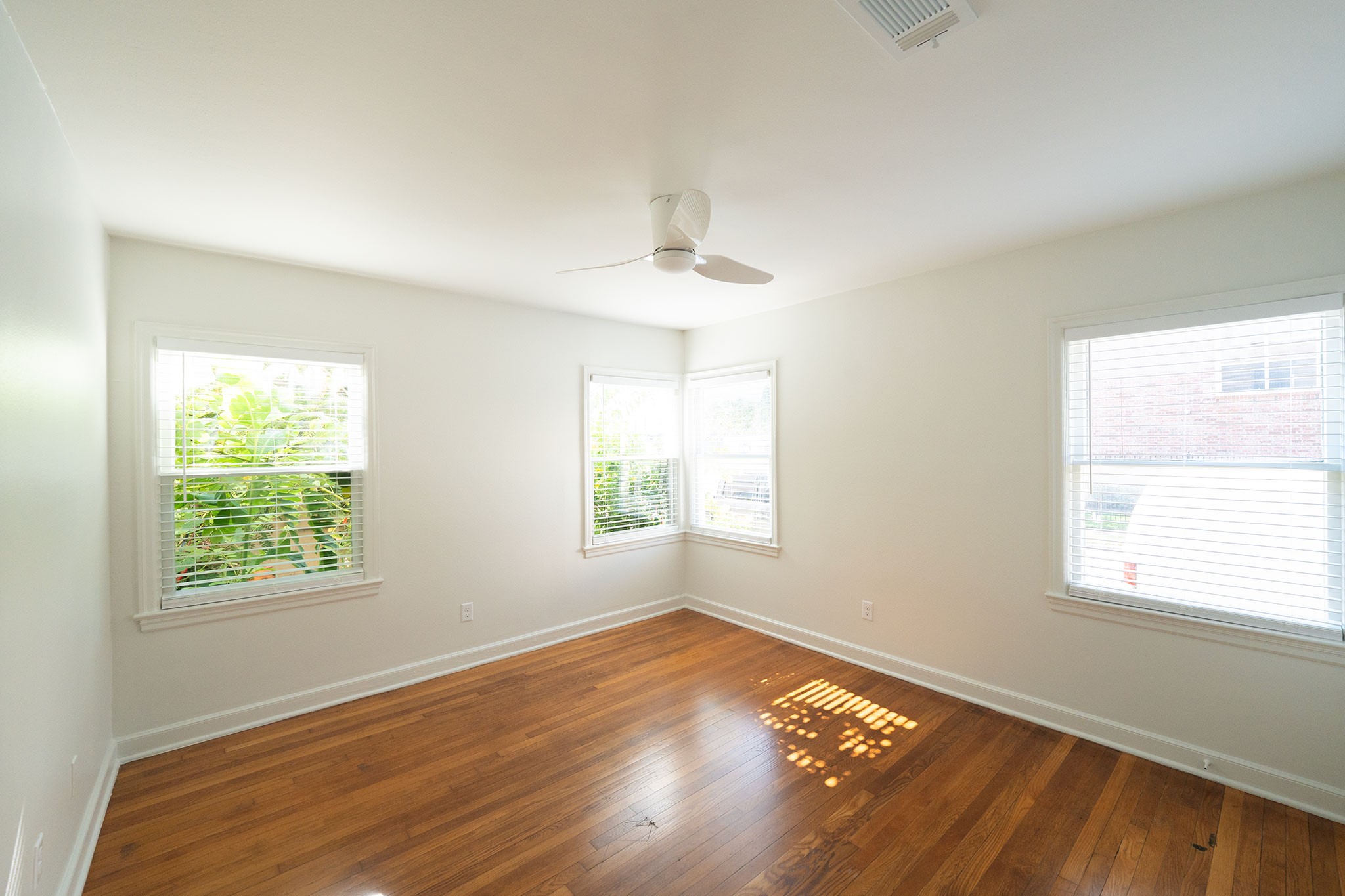 1917 Prospect Street, Unit 1 Houston, TX 77004 - Photo 3 of 16 a view of an empty room with wooden floor and a window