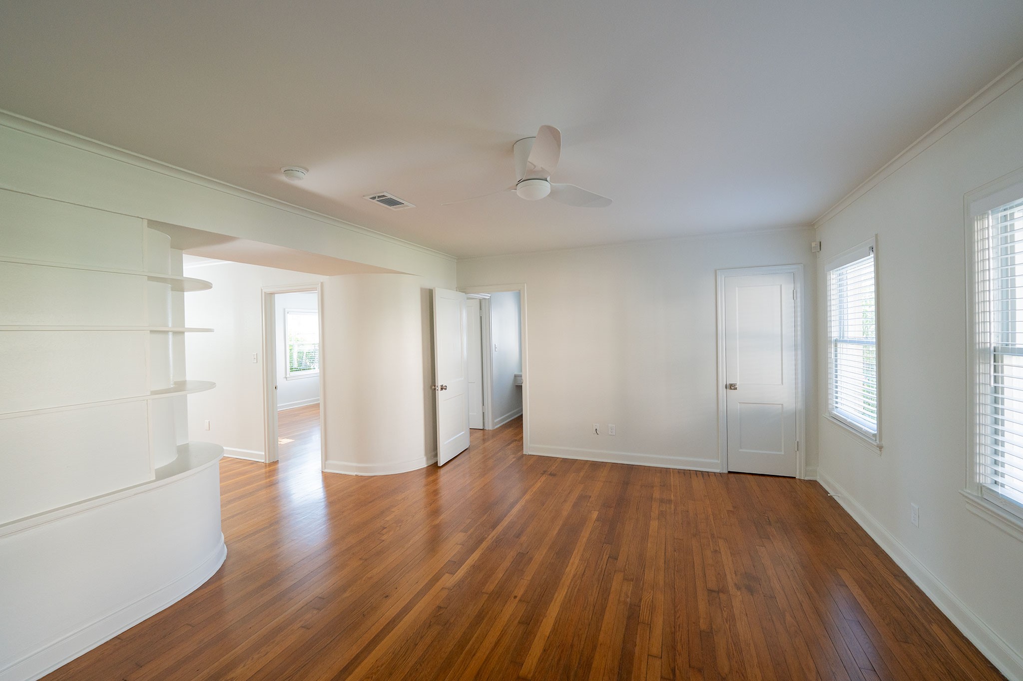 1917 Prospect Street, Unit 1 Houston, TX 77004 - Photo 6 of 16 an empty room with wooden floor and windows