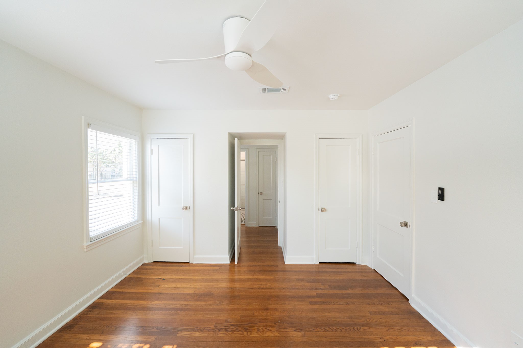 1917 Prospect Street, Unit 1 Houston, TX 77004 - Photo 7 of 16 a view of an empty room with wooden floor and a window