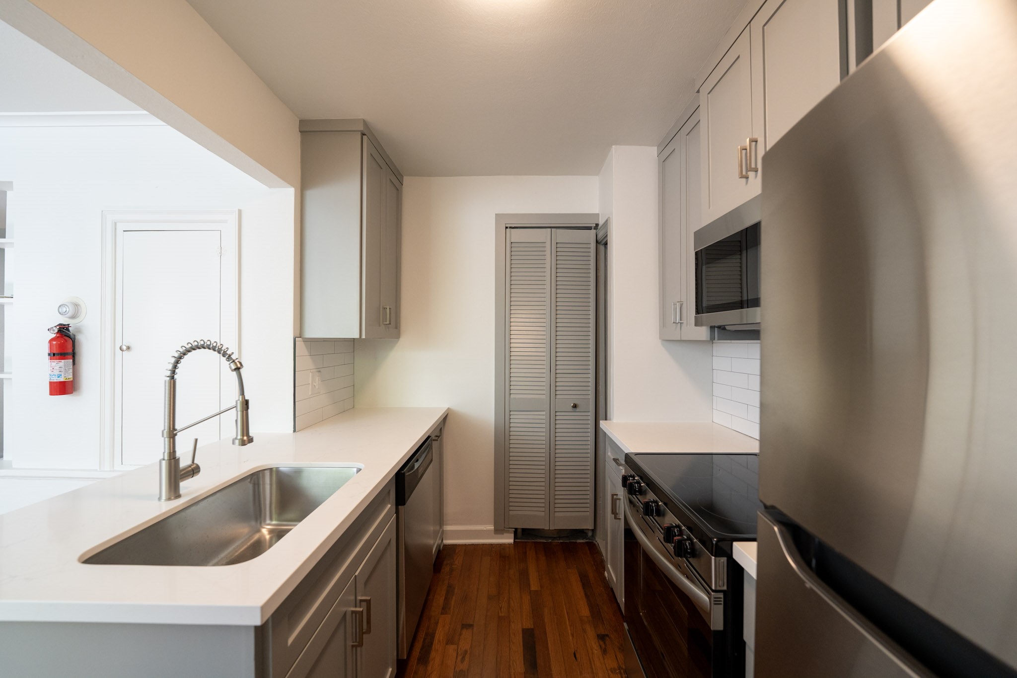 1917 Prospect Street, Unit 1 Houston, TX 77004 - Photo 9 of 16 a kitchen with stainless steel appliances a sink stove and cabinets