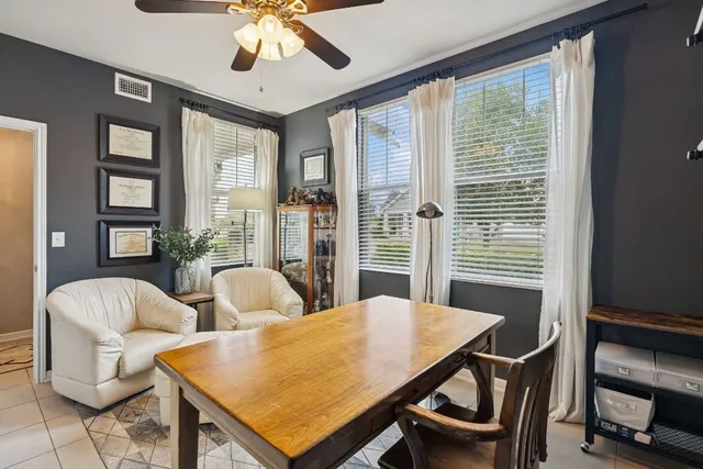 a living room with furniture and a potted plant