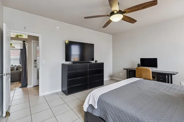 a bedroom with a bed and a flat screen tv