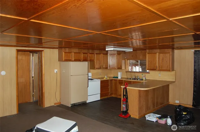 a kitchen with a refrigerator and a sink