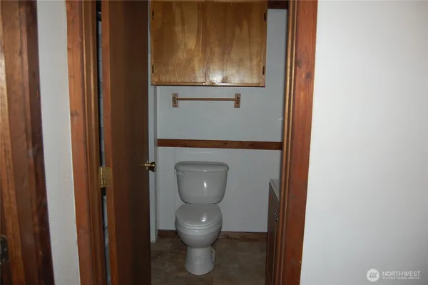 a view of a livingroom with wooden floor and a window