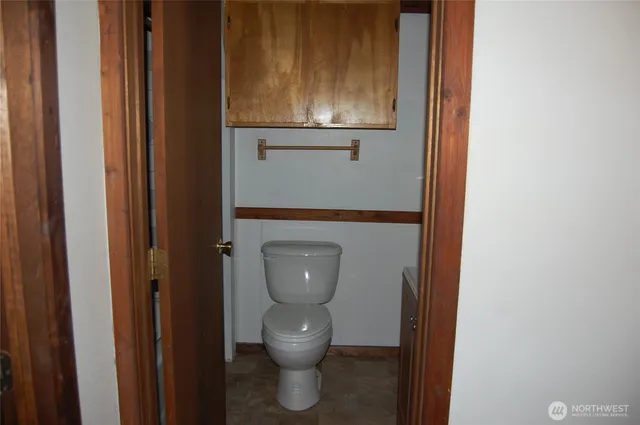 a view of a livingroom with wooden floor and a window
