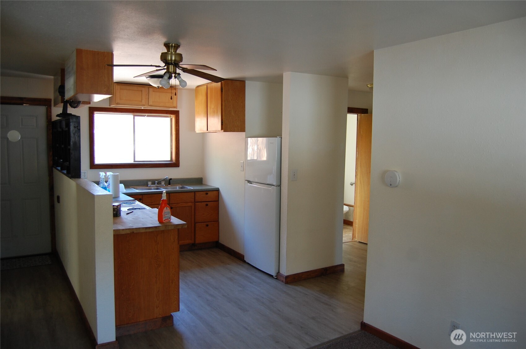117 Lake Street Conconully, WA 98819 - Photo 7 of 10 a view of a livingroom with wooden floor and a window