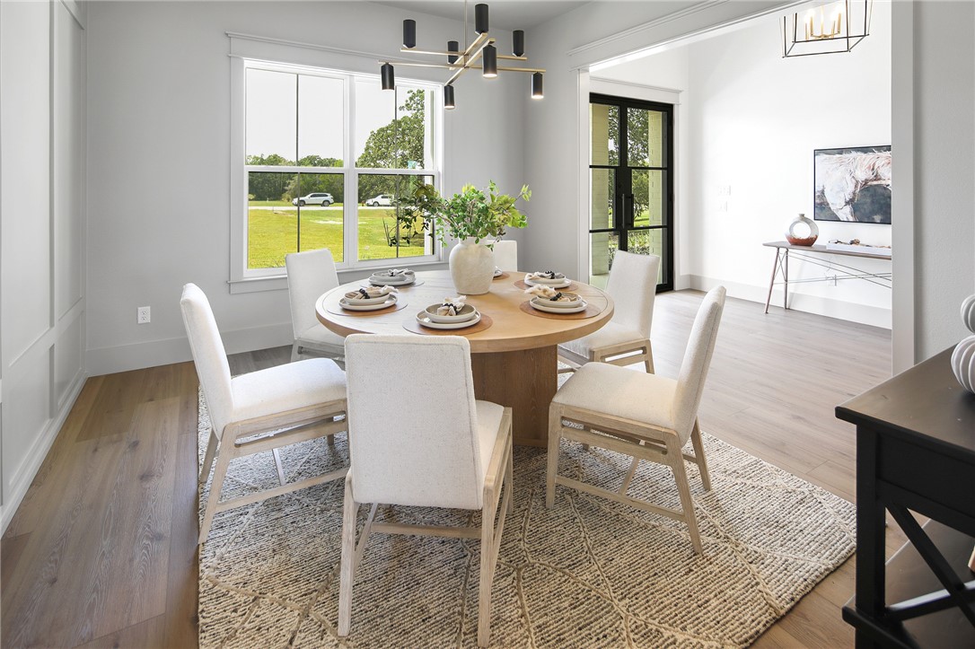 7933 Stiteler Drive Bryan, TX 77808 - Photo 14 of 44 a view of a dining room with furniture window and wooden floor