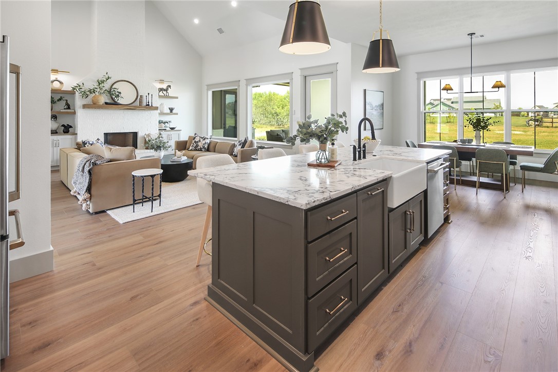 7933 Stiteler Drive Bryan, TX 77808 - Photo 28 of 44 a kitchen with stainless steel appliances granite countertop a stove and a wooden floors