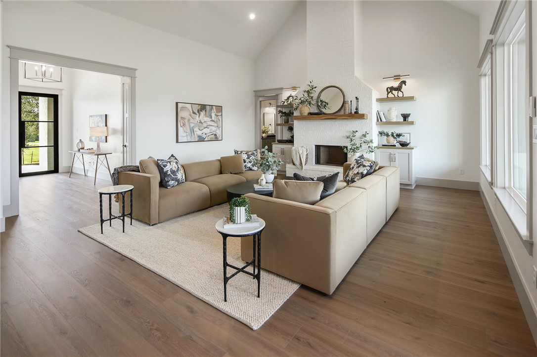 7933 Stiteler Drive Bryan, TX 77808 - Photo 4 of 44 a living room with furniture a fireplace and wooden floor