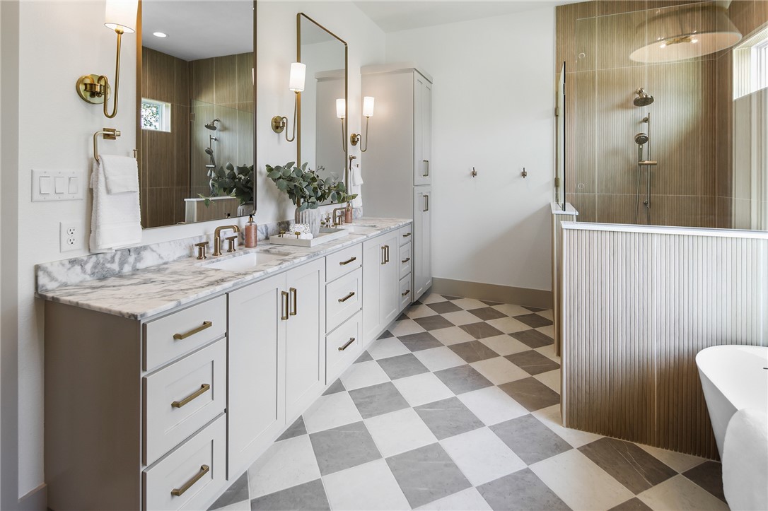 7933 Stiteler Drive Bryan, TX 77808 - Photo 6 of 44 a spacious bathroom with a sink a mirror and a shower