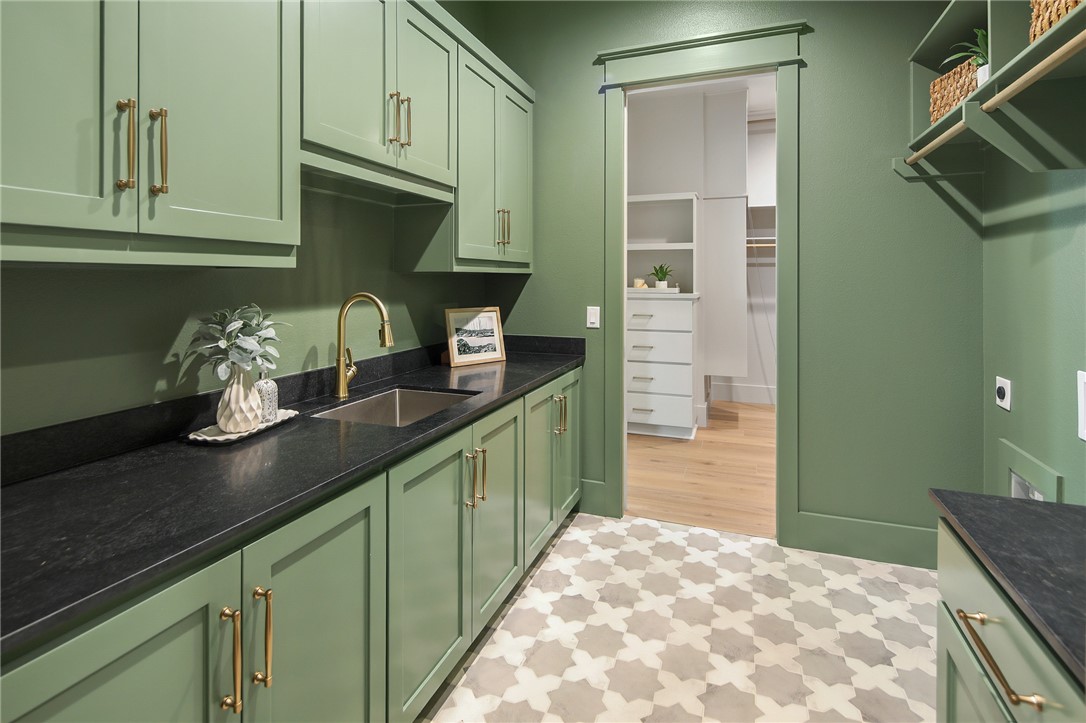 7933 Stiteler Drive Bryan, TX 77808 - Photo 7 of 44 a kitchen with granite countertop a sink stainless steel appliances and cabinets