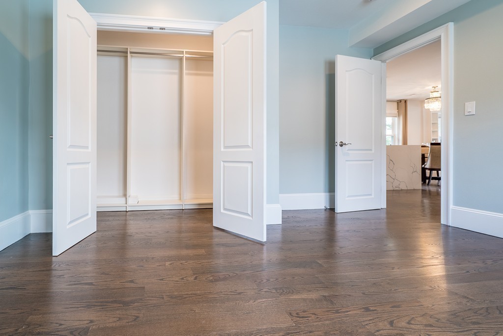 49 Fuller Road, Unit 2 Watertown, MA 02472 - Photo 10 of 23 a view of a hallway with wooden floor