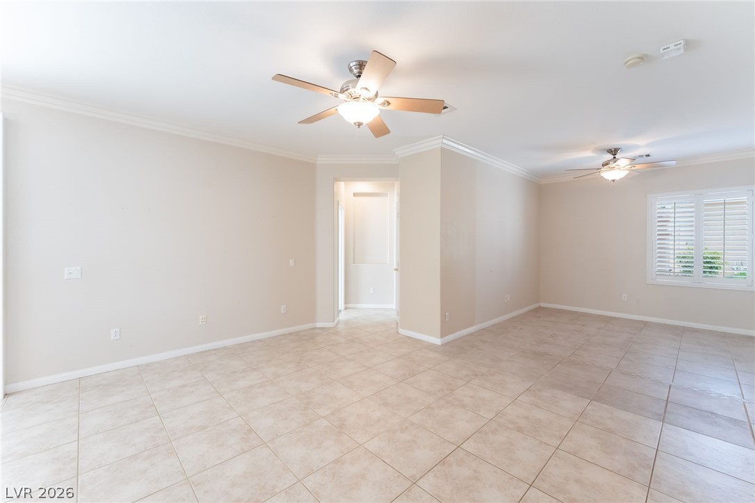 10481 Riverside Park Avenue Las Vegas, NV 89135 - Photo 6 of 51 Unfurnished room with crown molding, a ceiling fan, and light tile patterned floors