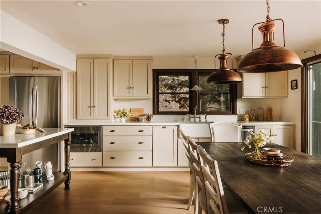 22771 Crest Forest Drive Crestline, CA 92325 - Photo 1 of 26 a kitchen with a stove a sink and a table