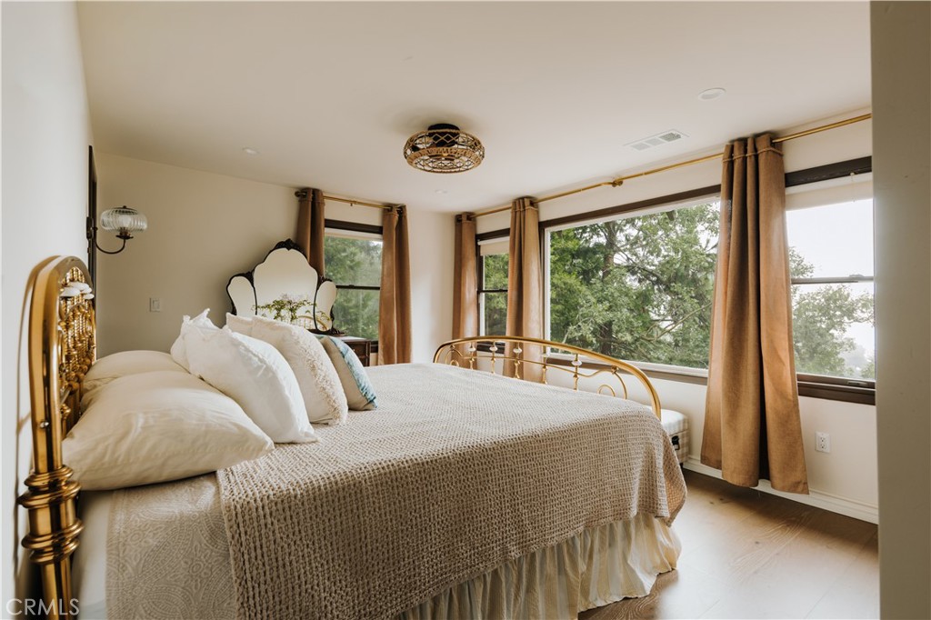 22771 Crest Forest Drive Crestline, CA 92325 - Photo 11 of 26 a bedroom with a bed and a large window