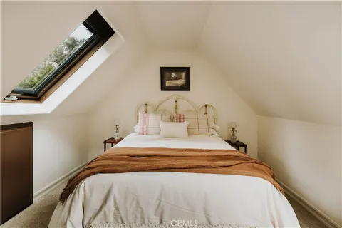 a bedroom with a bed and a night stand