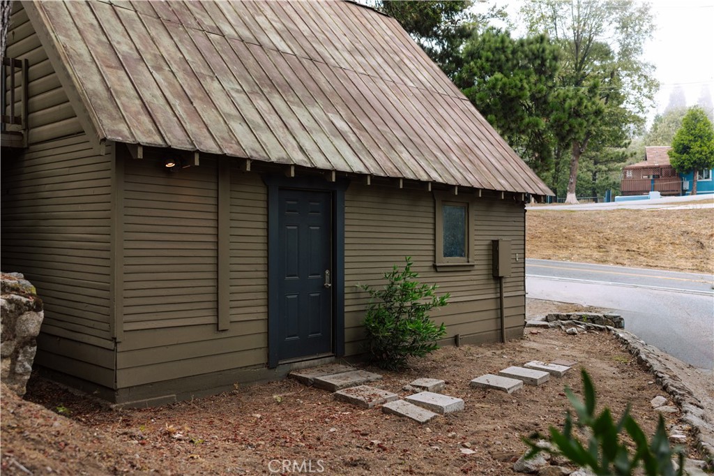 22771 Crest Forest Drive Crestline, CA 92325 - Photo 22 of 26 a front view of a house with garden