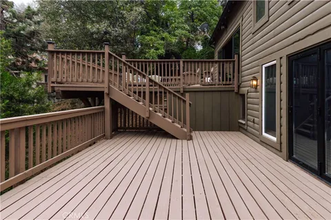 a view of deck with wooden floor and barbeque grill with wooden fence