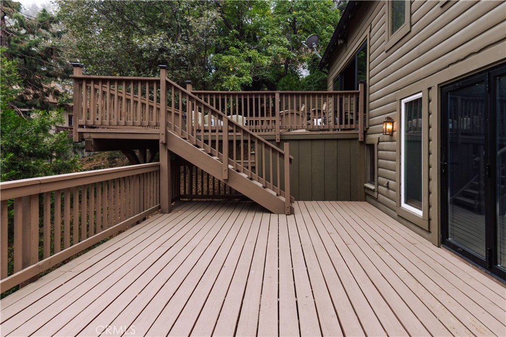 22771 Crest Forest Drive Crestline, CA 92325 - Photo 5 of 26 a view of deck with wooden floor and barbeque grill with wooden fence