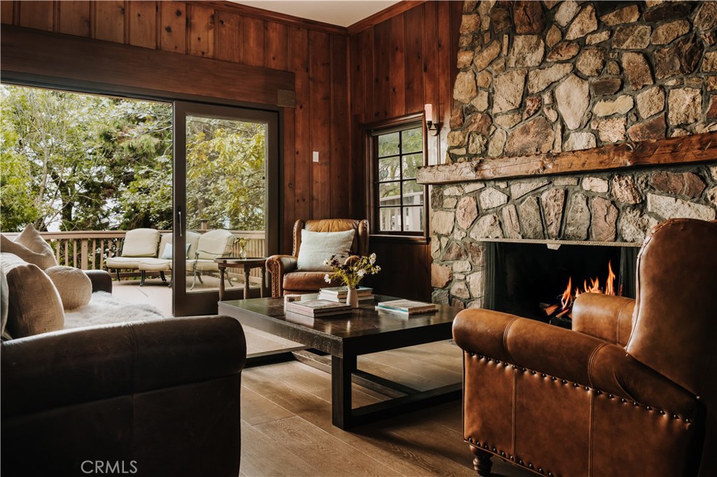 22771 Crest Forest Drive Crestline, CA 92325 - Photo 7 of 26 a living room with furniture a fireplace and a floor to ceiling window
