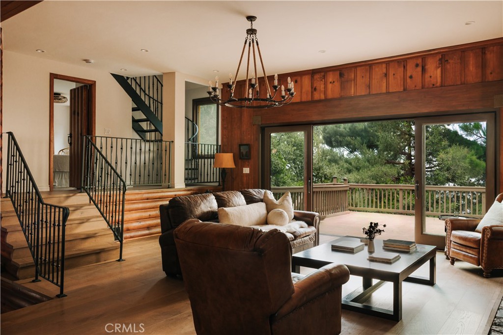 22771 Crest Forest Drive Crestline, CA 92325 - Photo 8 of 26 a living room with furniture a floor to ceiling window and wooden floor