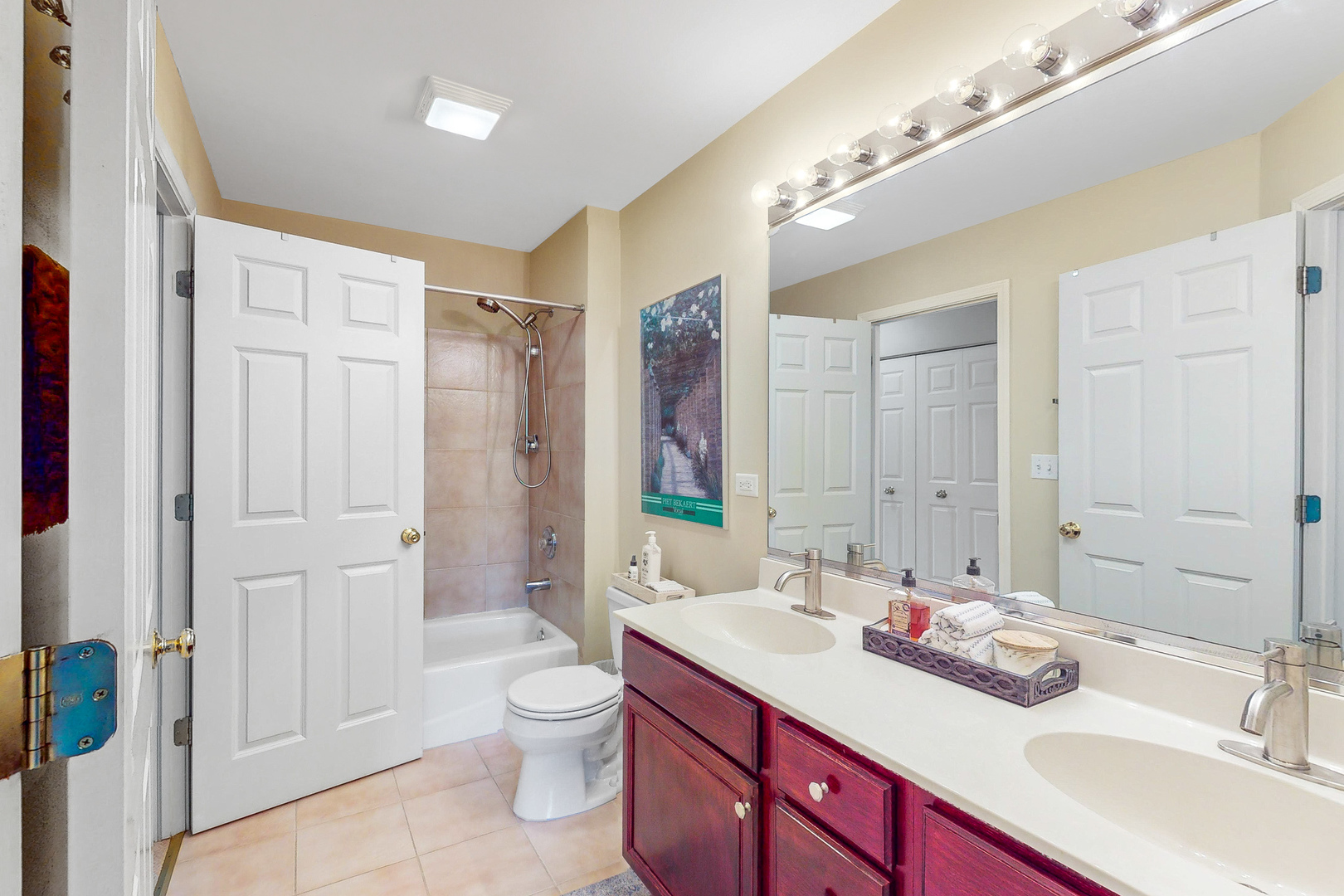 768 St Johns Place Addison, IL 60101 - Photo 19 of 34 a bathroom with a sink a toilet a large mirror and shower