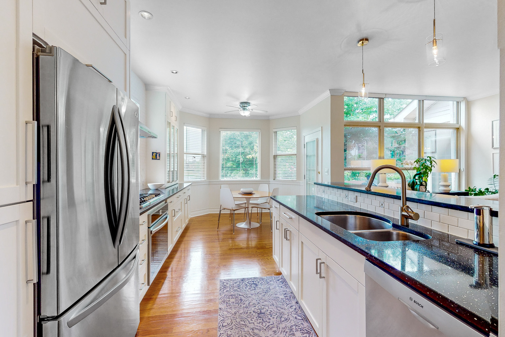 768 St Johns Place Addison, IL 60101 - Photo 6 of 34 a kitchen with stainless steel appliances a sink and a large window
